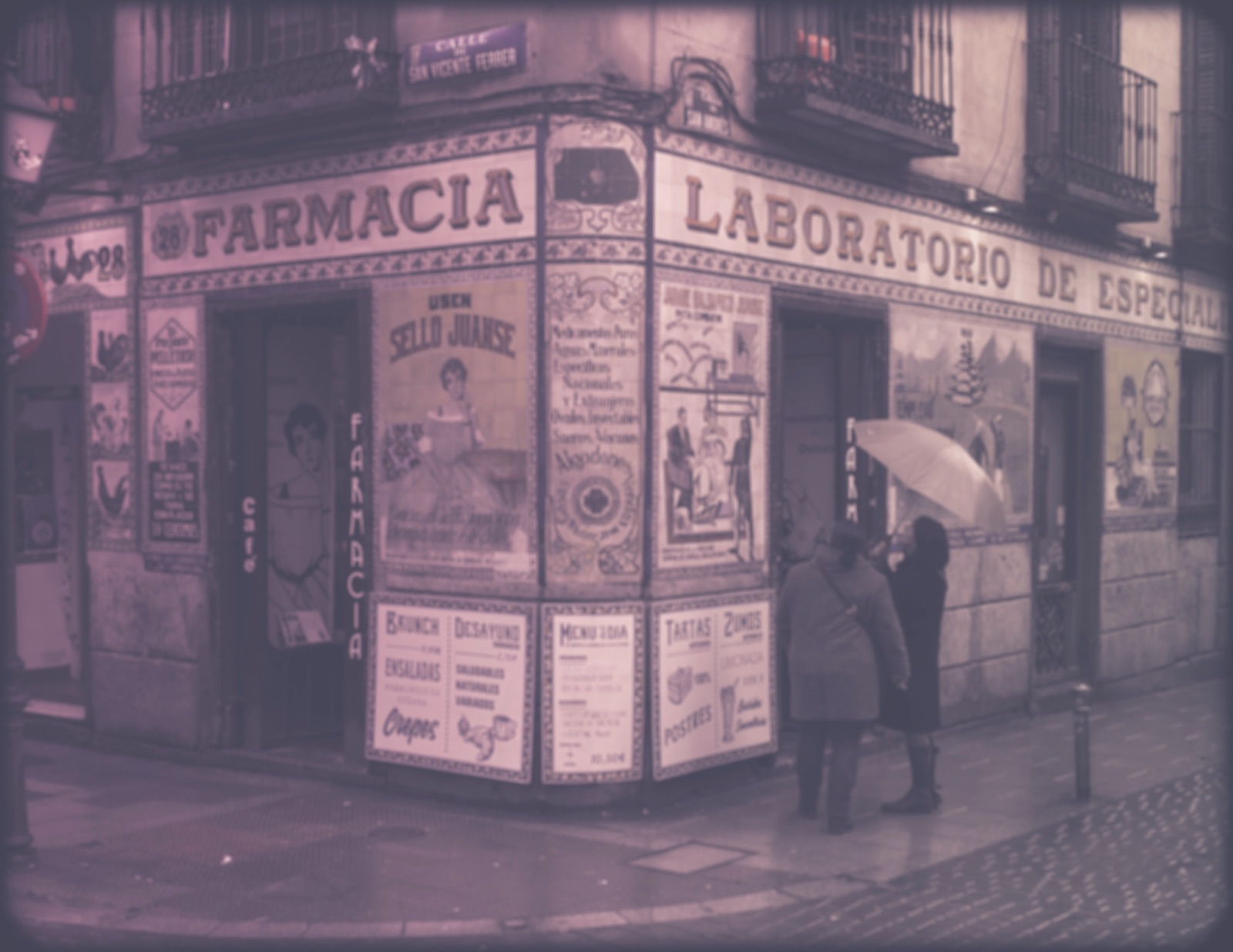 An old corner pharmacy with hand-painted tile signs
